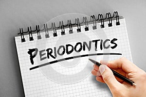 Hand writing Periodontics text on notepad, concept background