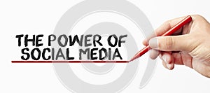 Hand writing THE POWER OF SOCIAL MEDIA with red marker.  on white background. Business, technology, internet concept.