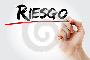 Hand writing Riesgo spanish words for Risk with marker, business concept photo