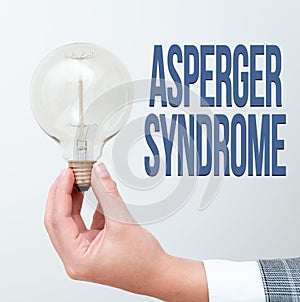 Hand writing sign Asperger Syndrome. Concept meaning characterized as a distinct autism spectrum disorder Hand holding