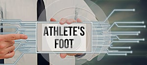 Hand writing sign Athlete& x27;s Foot. Business approach a fungus infection of the foot marked by blisters