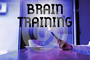 Hand writing sign Brain Training. Word Written on mental activities to maintain or improve cognitive abilities