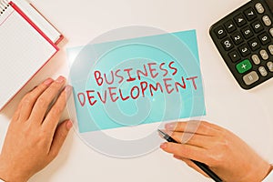 Hand writing sign Business Development. Business overview Implement Growth Value within and between company