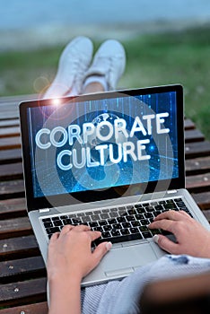 Hand writing sign Corporate Culture. Internet Concept Beliefs and ideas that a company has Shared values Laptop Resting