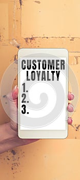 Hand writing sign Customer Loyalty. Conceptual photo buyers adhere to positive experience and satisfaction
