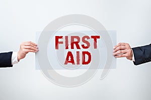 Hand writing sign First Aid. Conceptual photo Practise of healing small cuts that no need for medical training