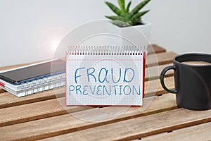 Hand writing sign Fraud Prevention. Word Written on to secure the enterprise and its processes against hoax