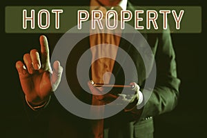 Hand writing sign Hot Property. Business showcase Something which is sought after or is Heavily Demanded Man Holding