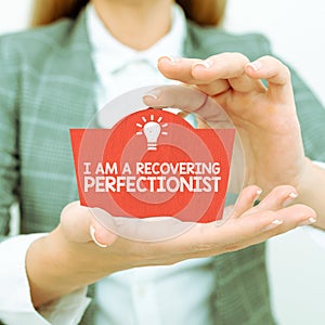 Hand writing sign I Am A Recovering Perfectionist. Word Written on Obsessive compulsive disorder recovery