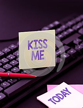 Hand writing sign Kiss Me. Concept meaning informally request to touch my lips with your lips or press against Copying