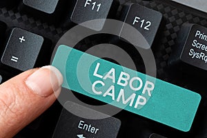 Hand writing sign Labor Camp. Word Written on a penal colony where forced labor is performed