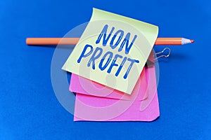 Hand writing sign Non Profit. Business showcase type of organization that does not earn profits for its owners Multiple