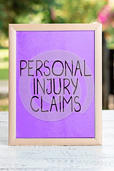 Hand writing sign personal injury claims. Concept meaning being hurt or injured inside work environment