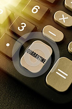 Hand writing sign Quarantine. Word Written on restraint upon the activities of person or the transport of goods Typing photo