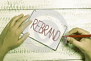 Hand writing sign Rebrand. Conceptual photo Change corporate image of company organization Marketing strategy