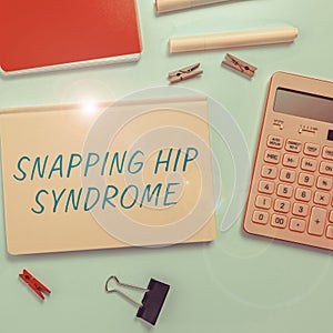 Hand writing sign Snapping Hip Syndrome. Word for audible snap or click that occurs in or around the hip