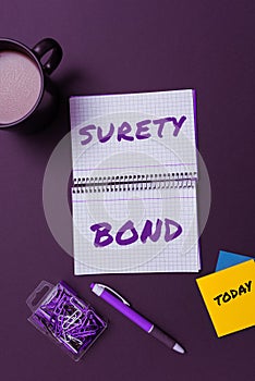 Hand writing sign Surety Bond. Business approach Formal legally enforceable contract between three parties