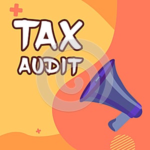 Hand writing sign Tax Audit. Word Written on examination or verification of a business or individual tax return