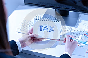 Hand writing sign Tax. Word for compulsory financial charge imposed upon taxpayer by government