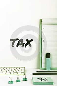 Hand writing sign Tax. Word for compulsory financial charge imposed upon taxpayer by government