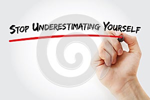 Hand writing Stop Underestimating Yourself with marker, concept background photo