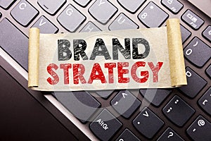 Hand writing text caption inspiration showing Brand Strategy. Business concept for Marketing Idea Plan written on sticky note pape