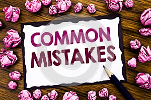 Hand writing text caption inspiration showing Common Mistakes. Business concept for Common Concept Written on sticky note paper, w