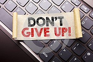 Hand writing text caption inspiration showing Don t Give Up. Business concept for Motivation Determination, written on sticky note