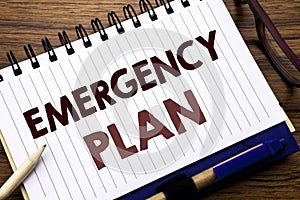 Hand writing text caption inspiration showing Emergency Plan. Business concept for Disaster Protection Written on notebook note pa