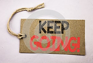 Hand writing text caption inspiration showing Keep Going. Business concept for Go Moving Forward Letting written on price tag pape