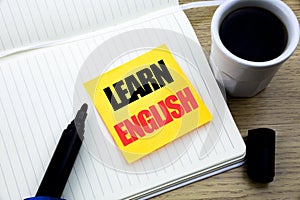 Hand writing text caption inspiration showing Learn English. Business concept for Language School written on sticky note paper, Wo