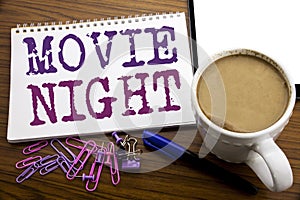 Hand writing text caption inspiration showing Movie Night. Business concept for Wathing Movies written on note paper on the woode