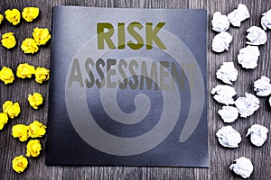 Hand writing text caption inspiration showing Risk Assessment. Business concept for Safety Danger Analyze Written on notepad note