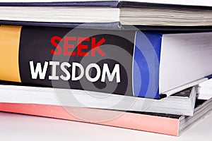 Hand writing text caption inspiration showing Seek Wisdom. Business concept for Inspiration Knowledge written on the book on the w