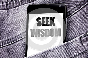 Hand writing text caption inspiration showing Seek Wisdom. Business concept for Inspiration Knowledge written mobile cell phone wi