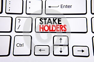 Hand writing text caption inspiration showing Stake Holders. Business concept for Stakeholder Engagement written on white keyboard