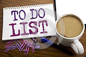 Hand writing text caption inspiration showing To Do List. Business concept for Plan Lists Remider written on note paper on the woo photo