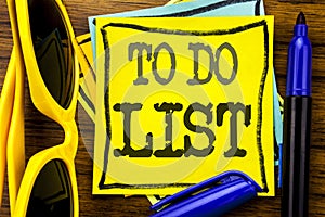 Hand writing text caption inspiration showing To Do List. Business concept for Plan Lists Remider Written on sticky note paper, wo photo