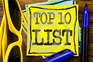 Hand writing text caption inspiration showing Top 10 Ten List. Business concept for Success ten list Written on sticky note paper,