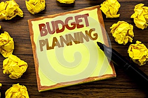 Hand writing text caption showing Budget Planning. Business concept for Financial Budgeting Written on sticky note paper, wooden b