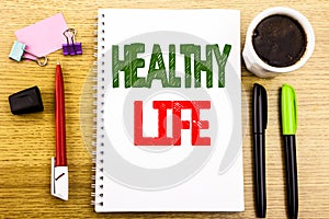 Hand writing text caption showing Healthy Life. Business concept for Good Health Food Written on notepad note paper background wit