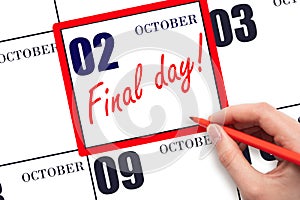 Hand writing text FINAL DAY on calendar date October 2. A reminder of the last day. Deadline. Business concept.