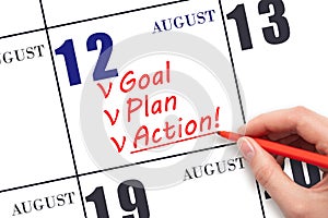 Hand writing text GOAL PLAN ACTION on calendar date August 12. Motivation for a new day. Business concept.