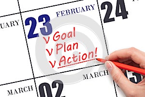 Hand writing text GOAL PLAN ACTION on calendar date February 23. Motivation for a new day. Business concept.