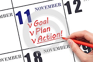 Hand writing text GOAL PLAN ACTION on calendar date November 11. Motivation for a new day. Business concept.