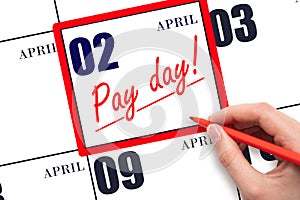 Hand writing text PAY DATE on calendar date April 2 and underline it. Payment due date