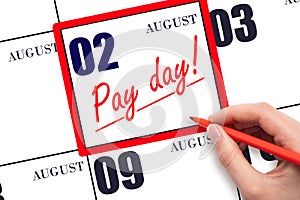 Hand writing text PAY DATE on calendar date August 2 and underline it. Payment due date