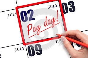 Hand writing text PAY DATE on calendar date July 2 and underline it. Payment due date