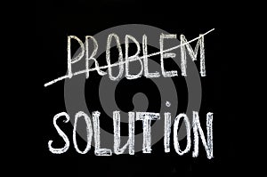 Hand writing text `problem and solution` on chalkboard