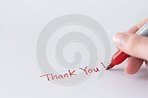 Hand writing thank you note using red marker pen